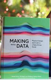Lora Oehlberg and Wesley Willett pose with their book, Making with Data: Physical Design and Craft in a Data-Driven World