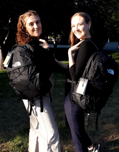 Victoria Lambrinoudis and Morgan Richardson with their new travel gift packs, generously donated by Hostelling International Calgary