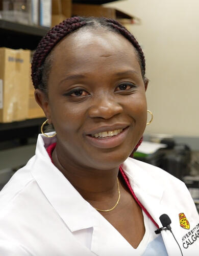 Dr. Ibukun Akinrinade in her lab coat