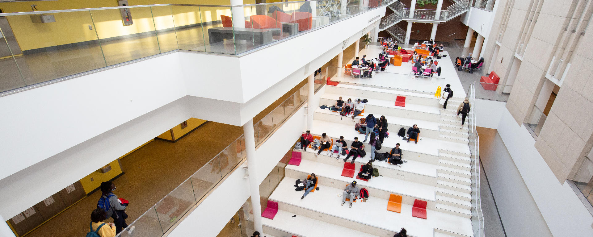 Students sitting in the atrium of an engineering building.
