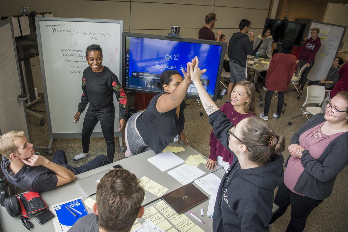 Quality Teaching and Learning Students high fiving over project