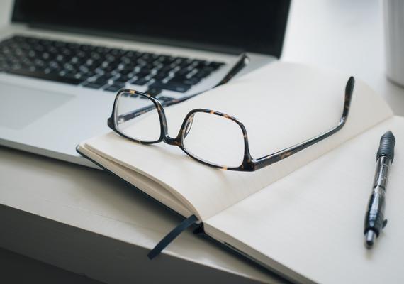 Laptop, notebook, glasses and a pen
