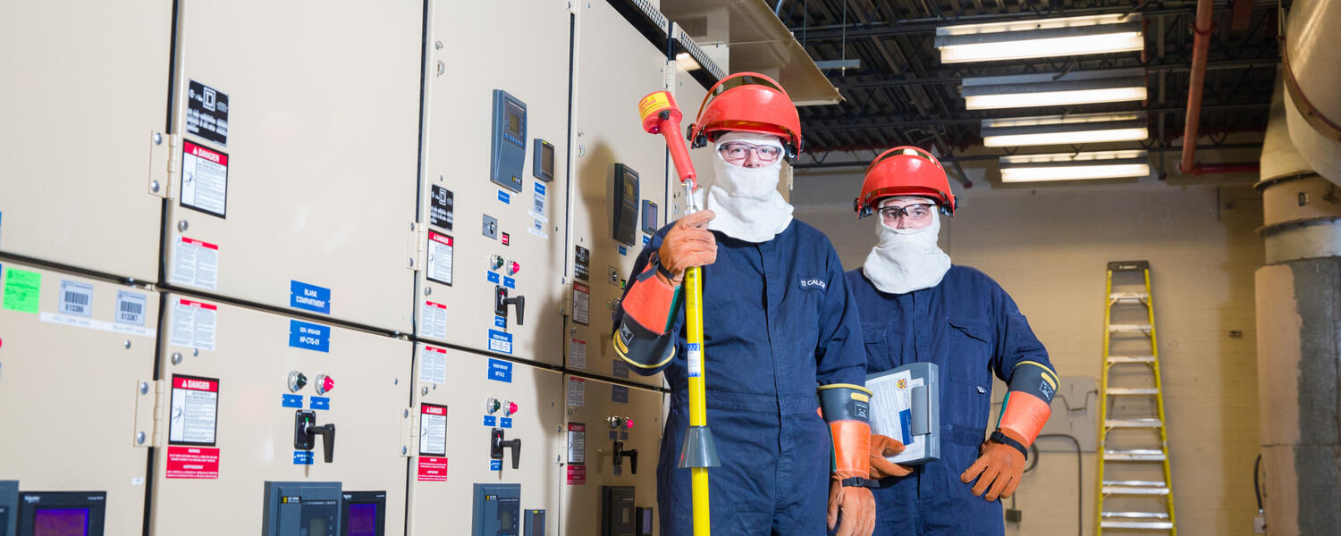 Two workers in Personal Protective Equipment