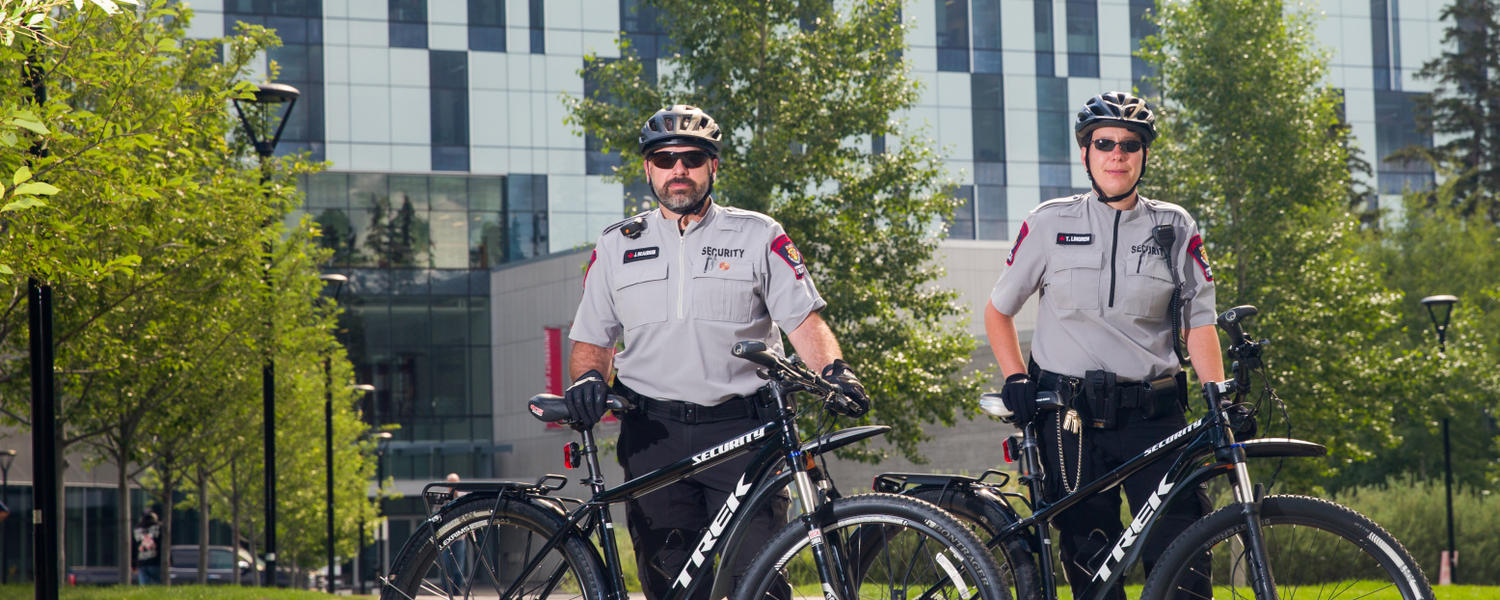 Two security officers ride their bikes on campus.