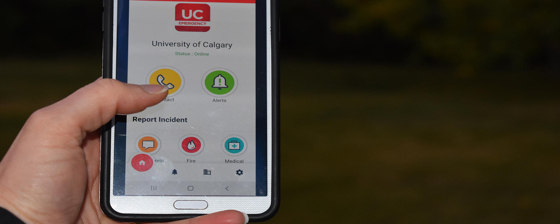 Image of smart phone with UC Emergency Mobile app opened to home screen