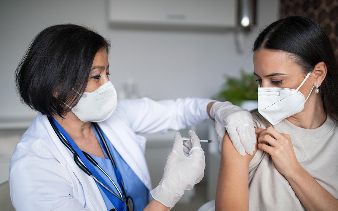 Woman receiving her vaccine Woman receiving her vaccine