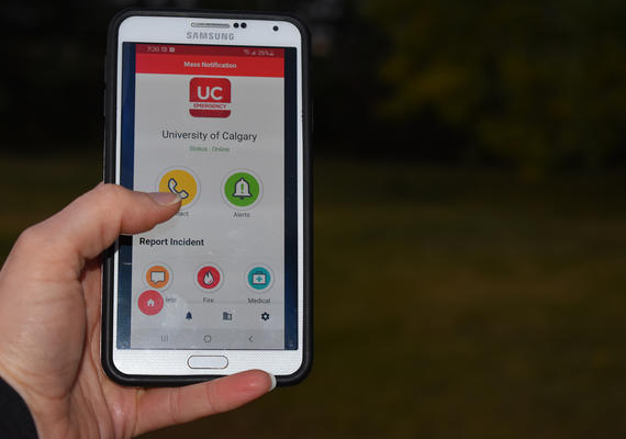 Hand showing open UC Emergency Mobile app