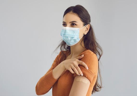 people with a mask and band aide on arm 