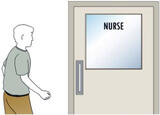 A person walking towards a nurses room.