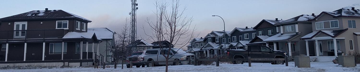 houses in a suburban neighbourhood on a winter day with blue late afternoon skies