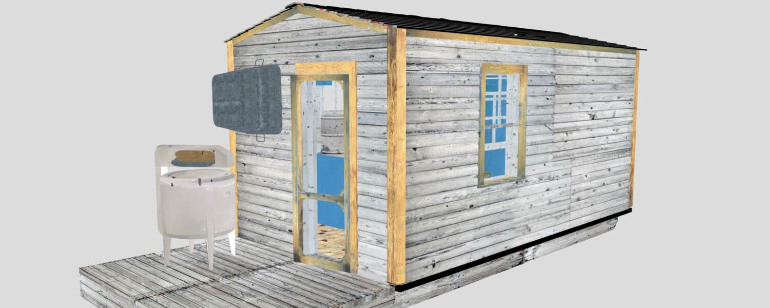 Image of 3D model of skid shack - a small grey wooden cabin with a washing machine on the outside porch, a window and a door.