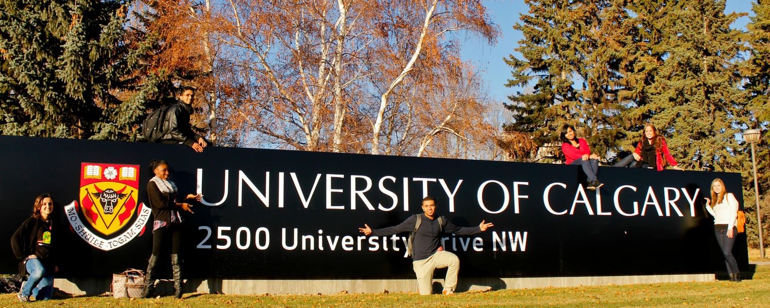 Image of exchange students in front of UCalgary sign