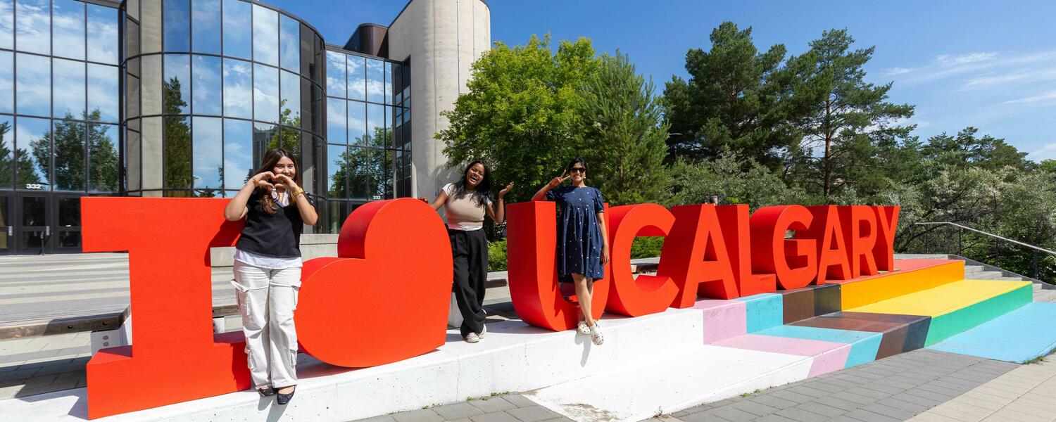 Summer brings together the community during the President's BBQ. Three students pose in front of large letters that read I heart UCalgary.