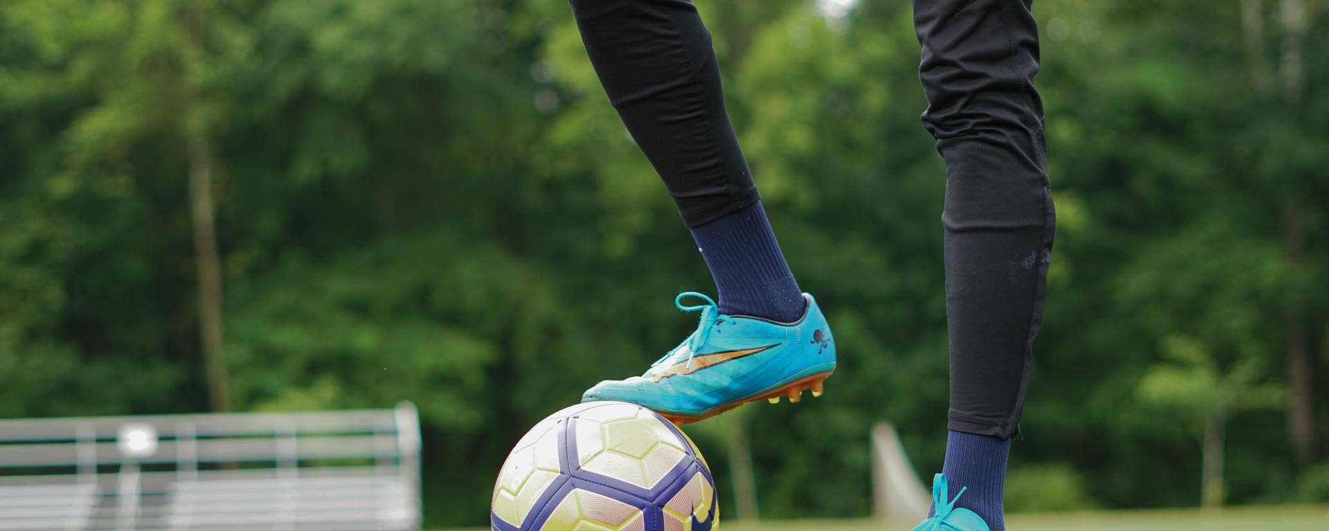 Soccer athlete with ball at feet