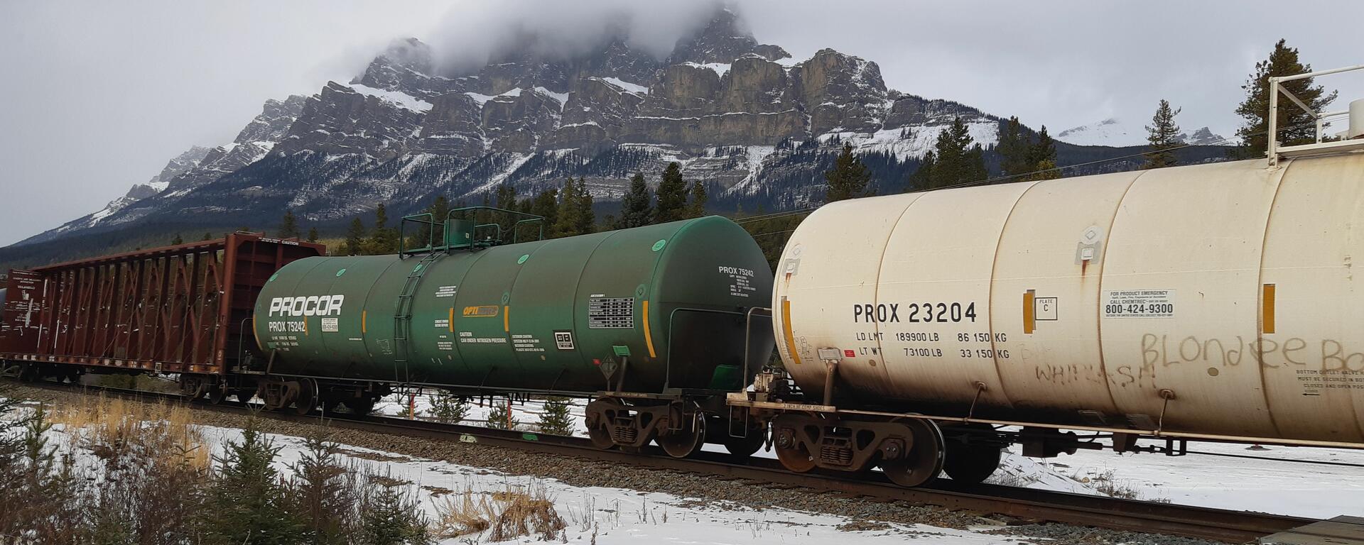 Train cars passing through Rocky Mountains Alberta
