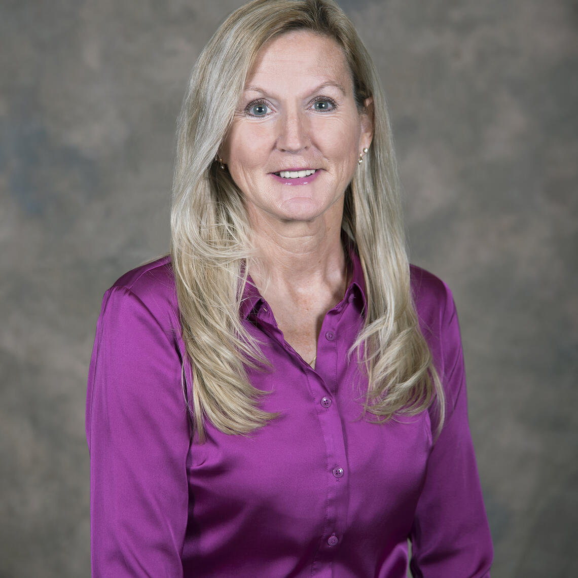 Teri McKinnon smiling at the camera for their headshot