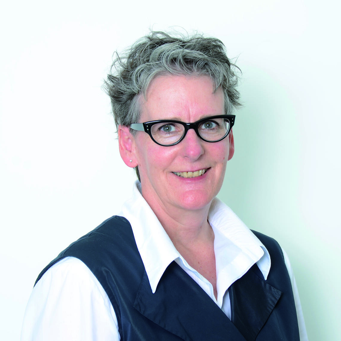 Katherine Wagner smiling at the camera with a white backdrop