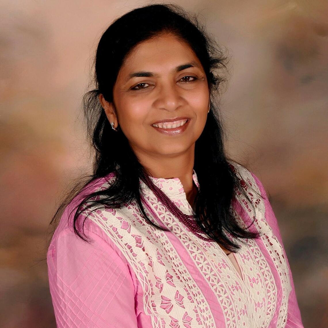 Nidhi smiling at the camera