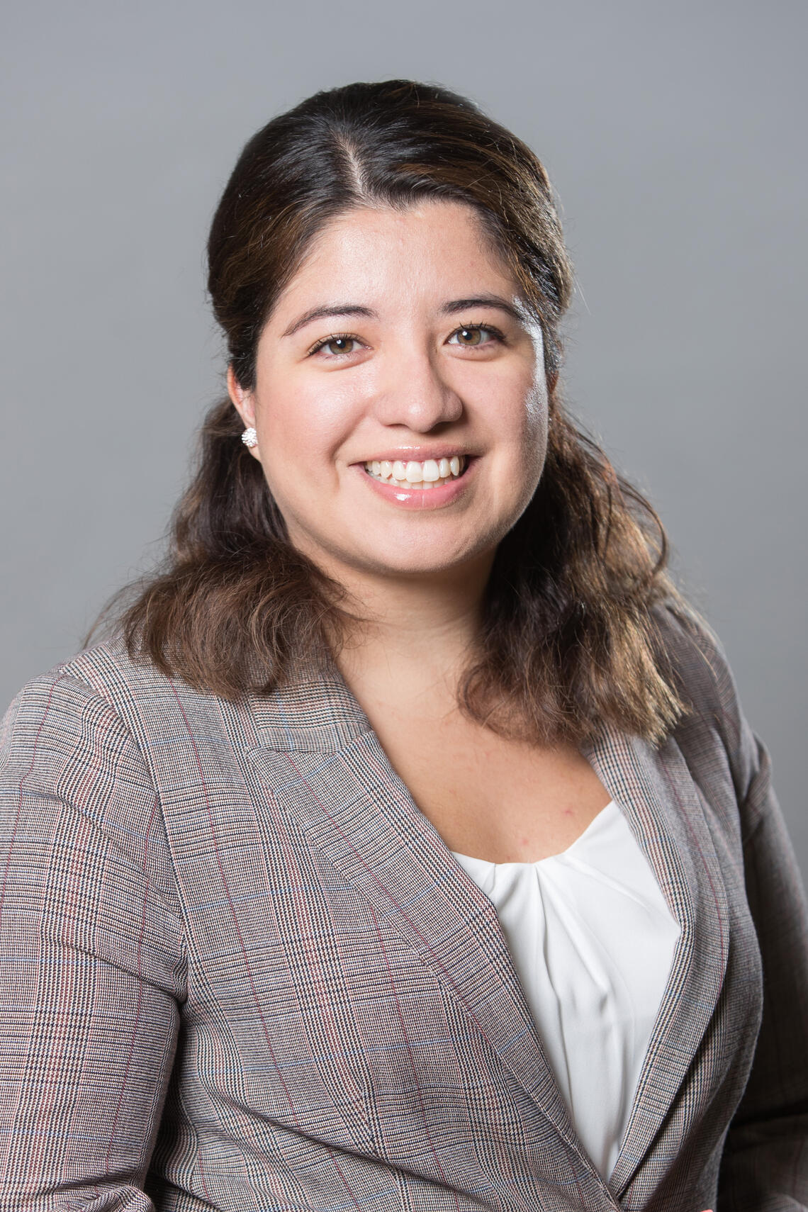 Headshot of Nicole wearing a grey suit and white blouse.