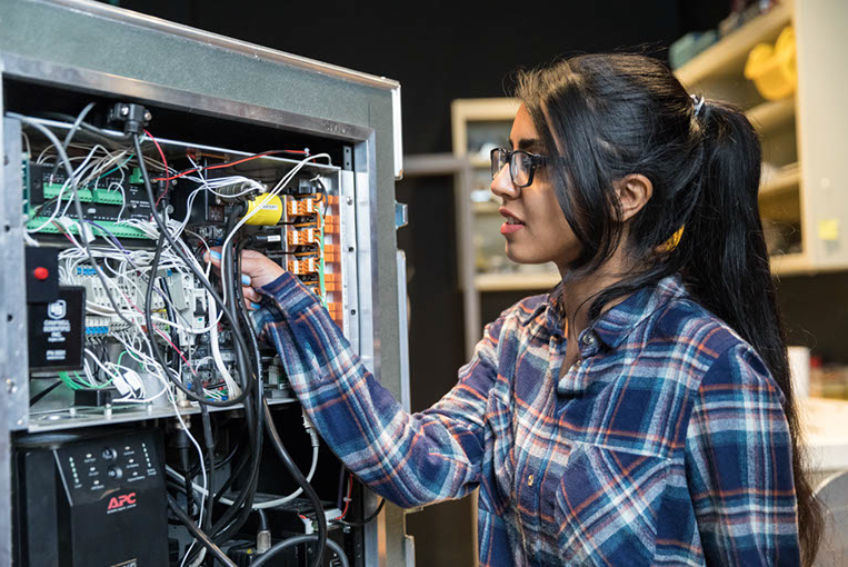 Student observing wires Student observing wires