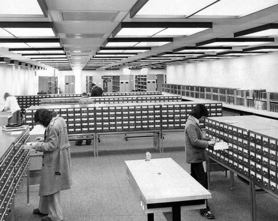 Image of students using the University of Calgary library card catalogue cabinets. Image of students using the University of Calgary library card catalogue cabinets.