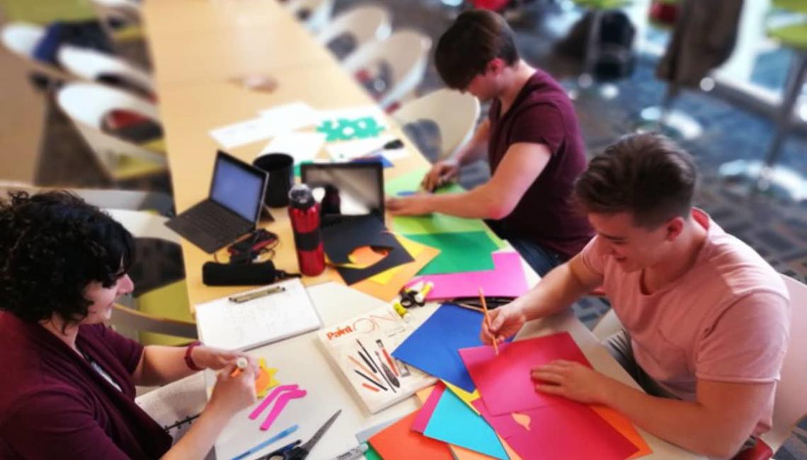 Janine, Kaiden, and Michael helping Maria in making the puppet booth for Soapbox Science
