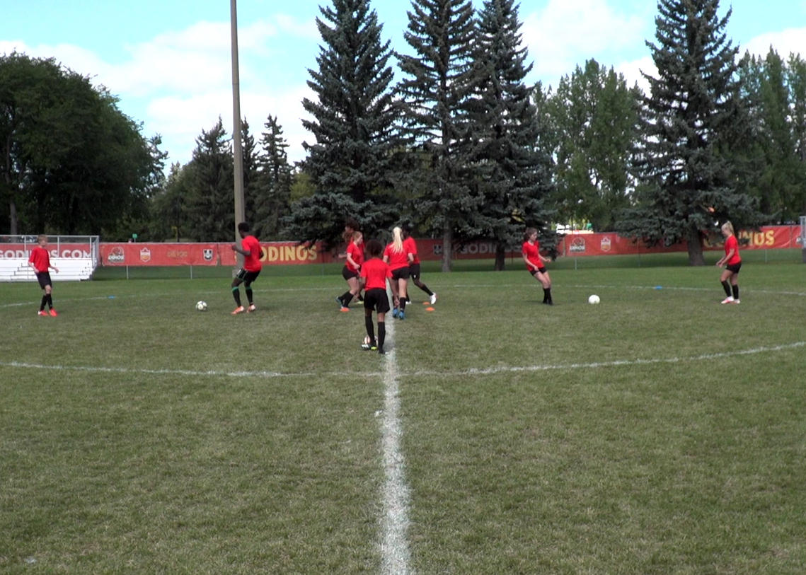 Soccer players performing passing drill with chaos in center