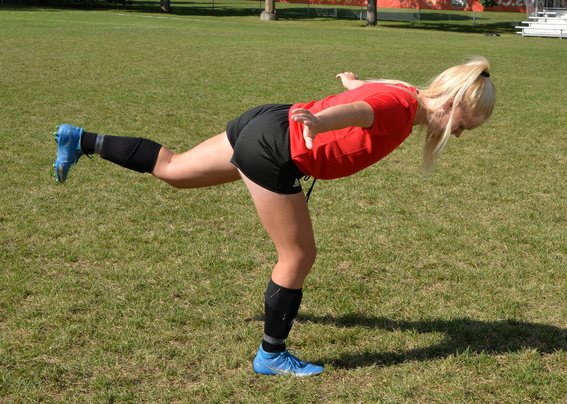 Soccer player performing airplane balance