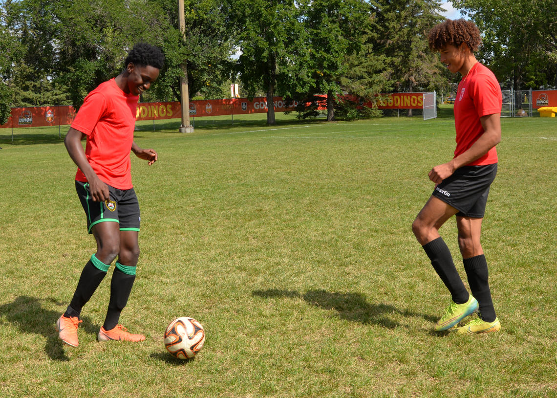 Soccer players passing ball while staying on a single-leg