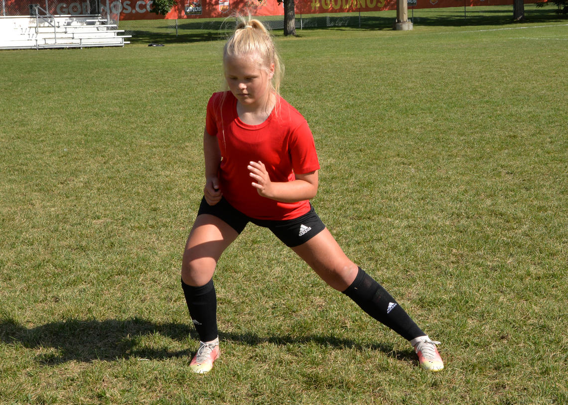 Soccer athlete performing lateral lunges
