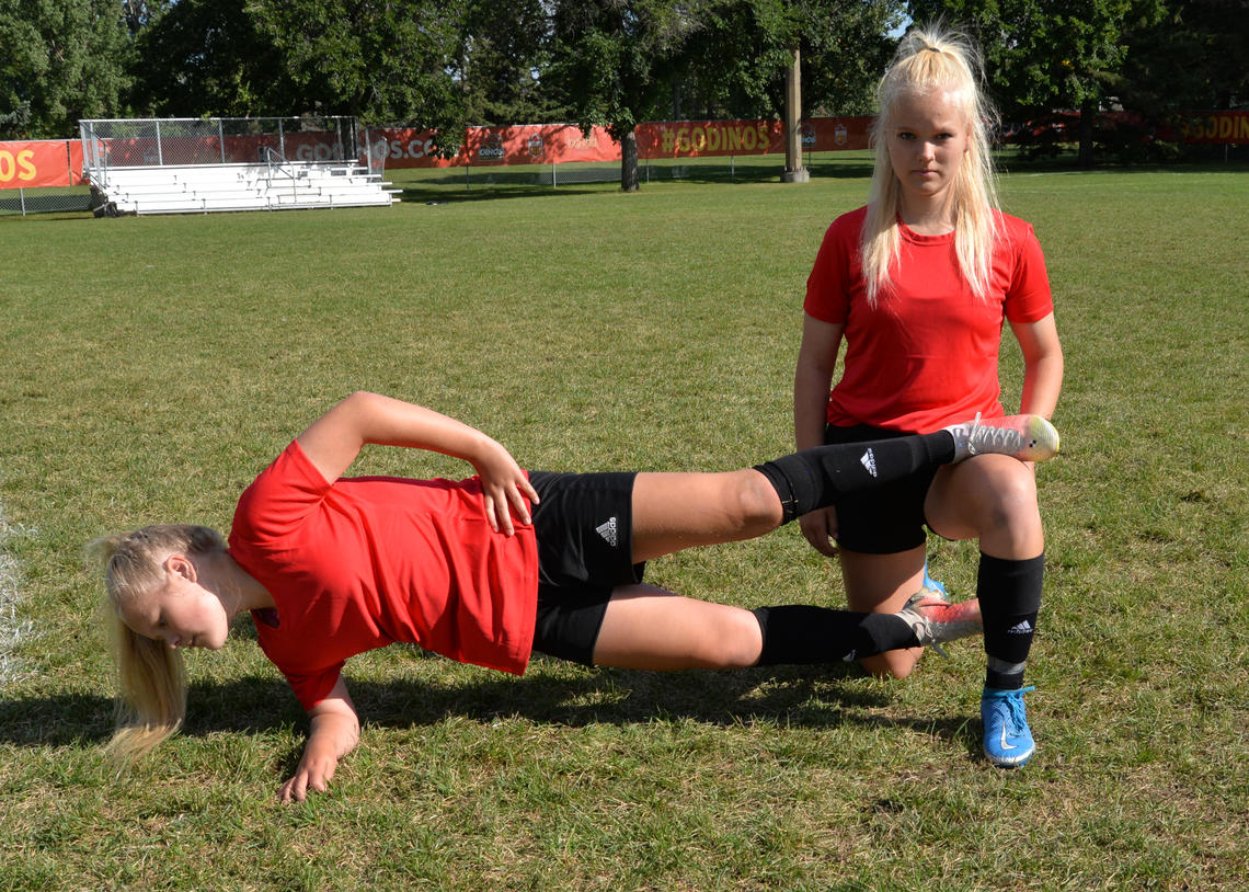 Soccer athletes performing copenhagen adductor exercise with foot supported hold