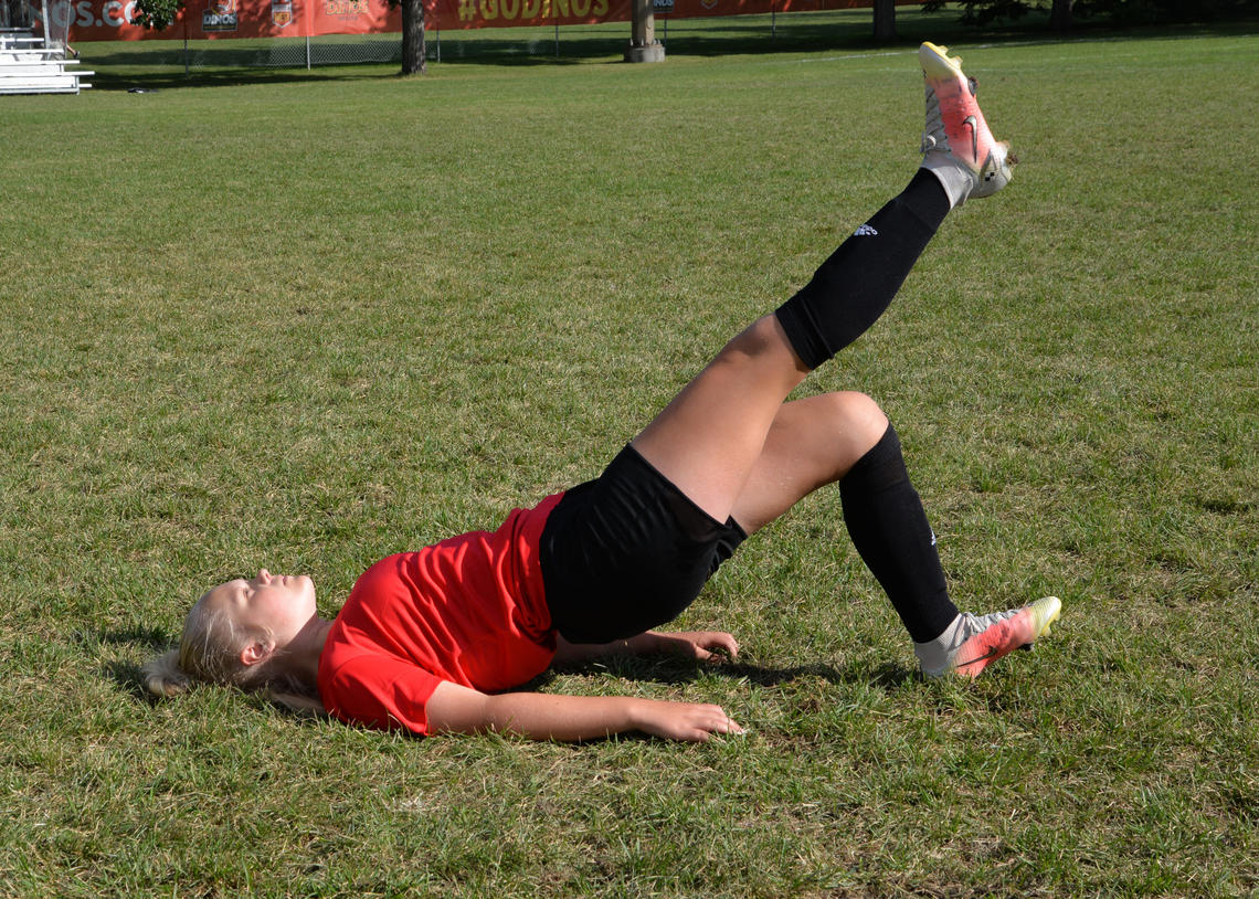 Soccer player performing single-leg glute bridge