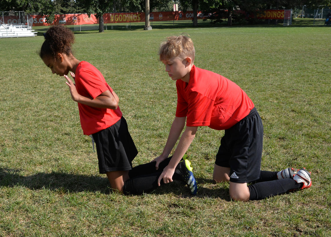 Soccer athletes performing a nordic hamstring curl
