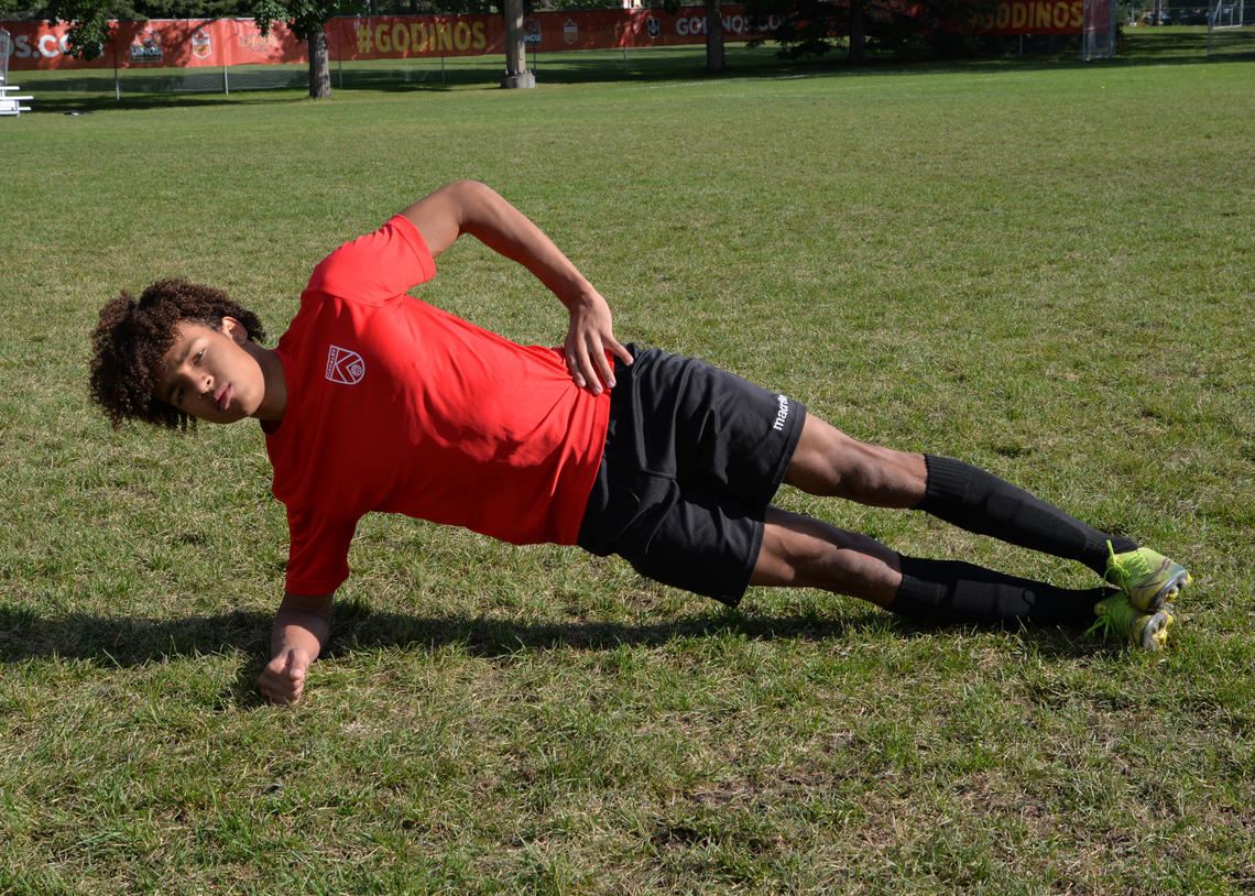 Soccer athlete performing side plank