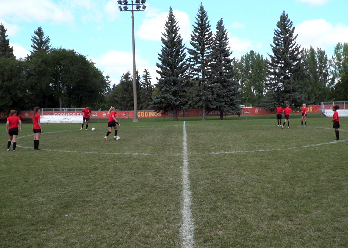 Soccer athletes performing pass and turn drill