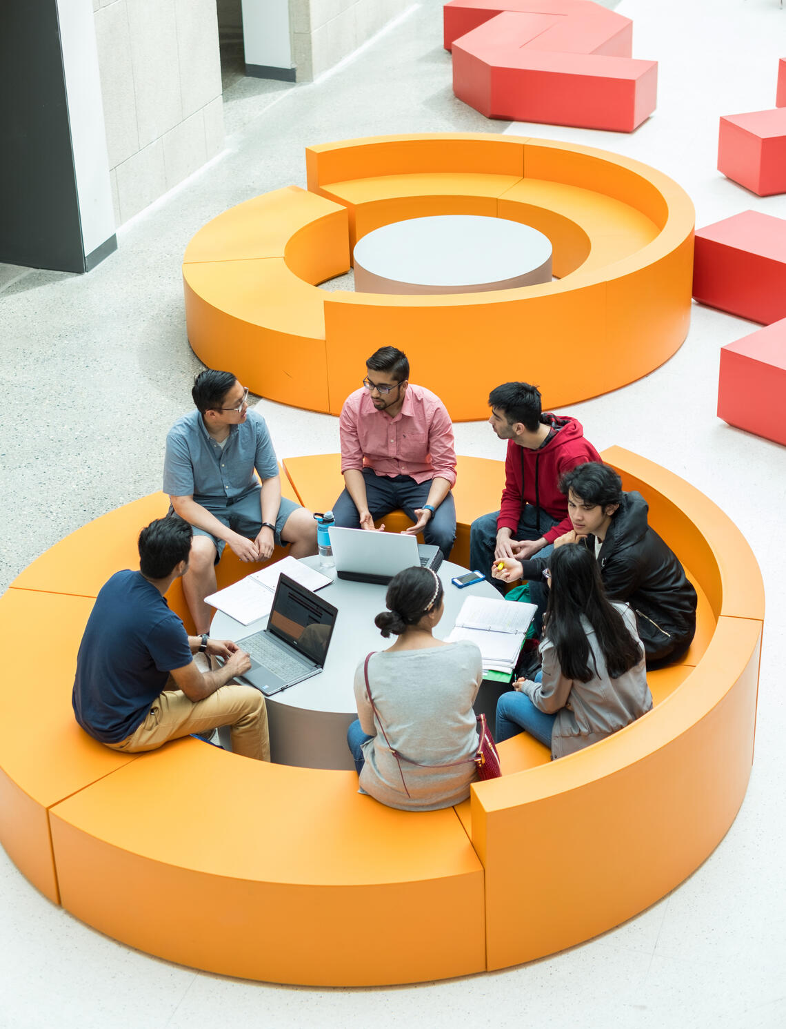Students sitting in a group talking with each other.