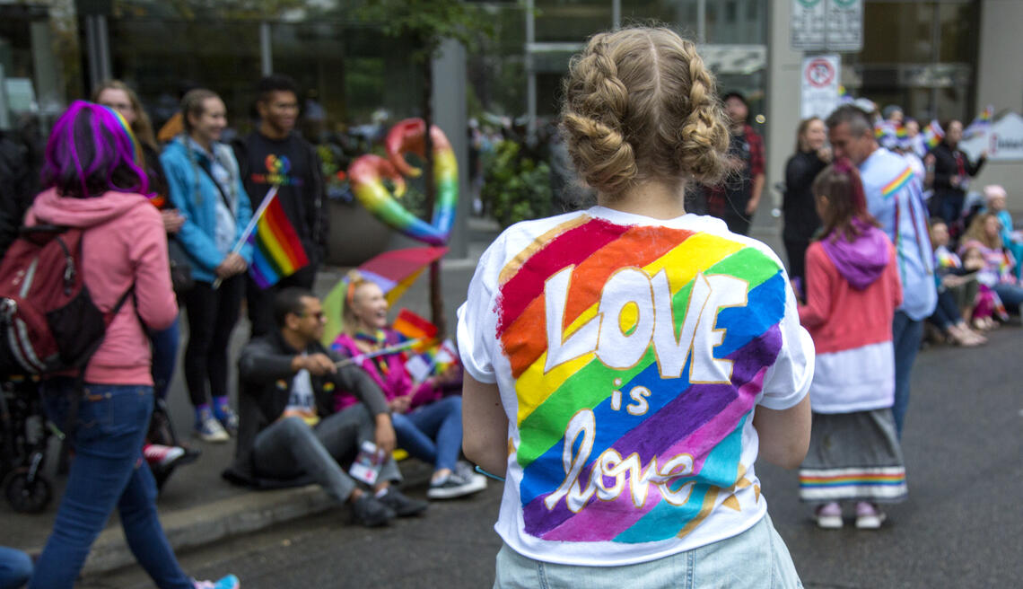 Students and community members participating in a Calgary Pride parade.