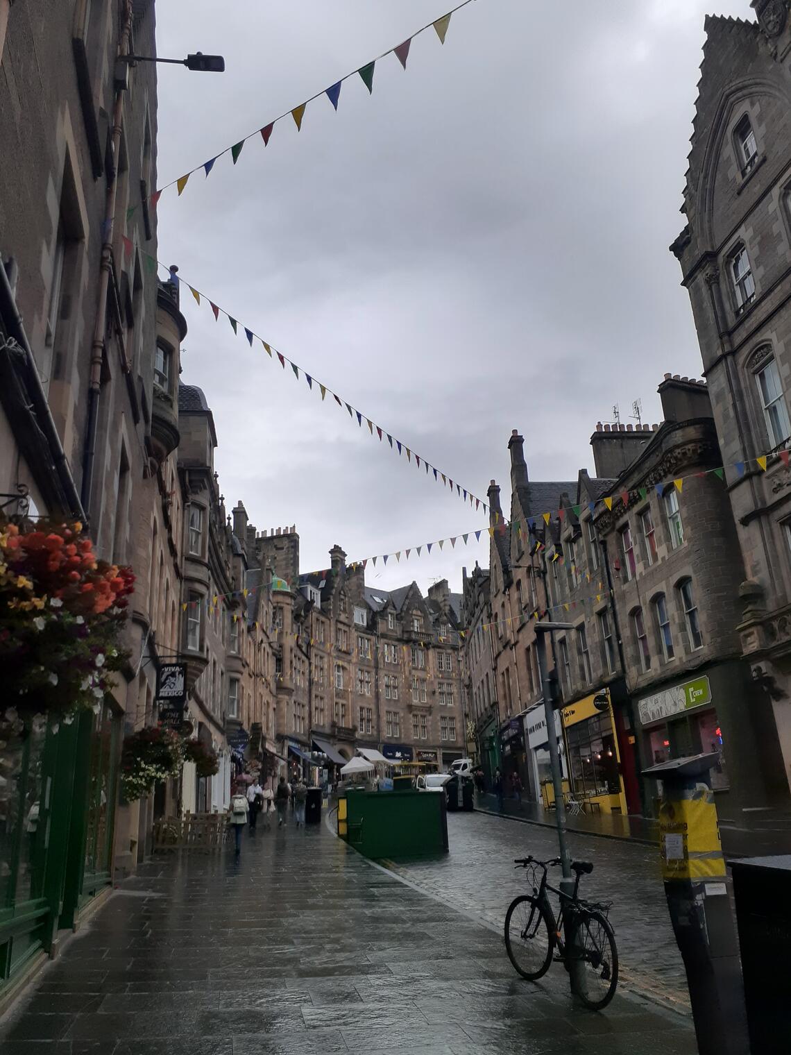 Rainy street in Edinburgh, looking up towards a cloudy sky