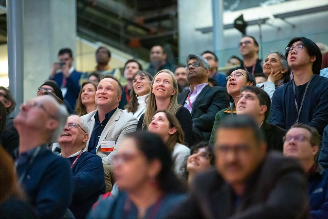 Group of people smiling in audience
