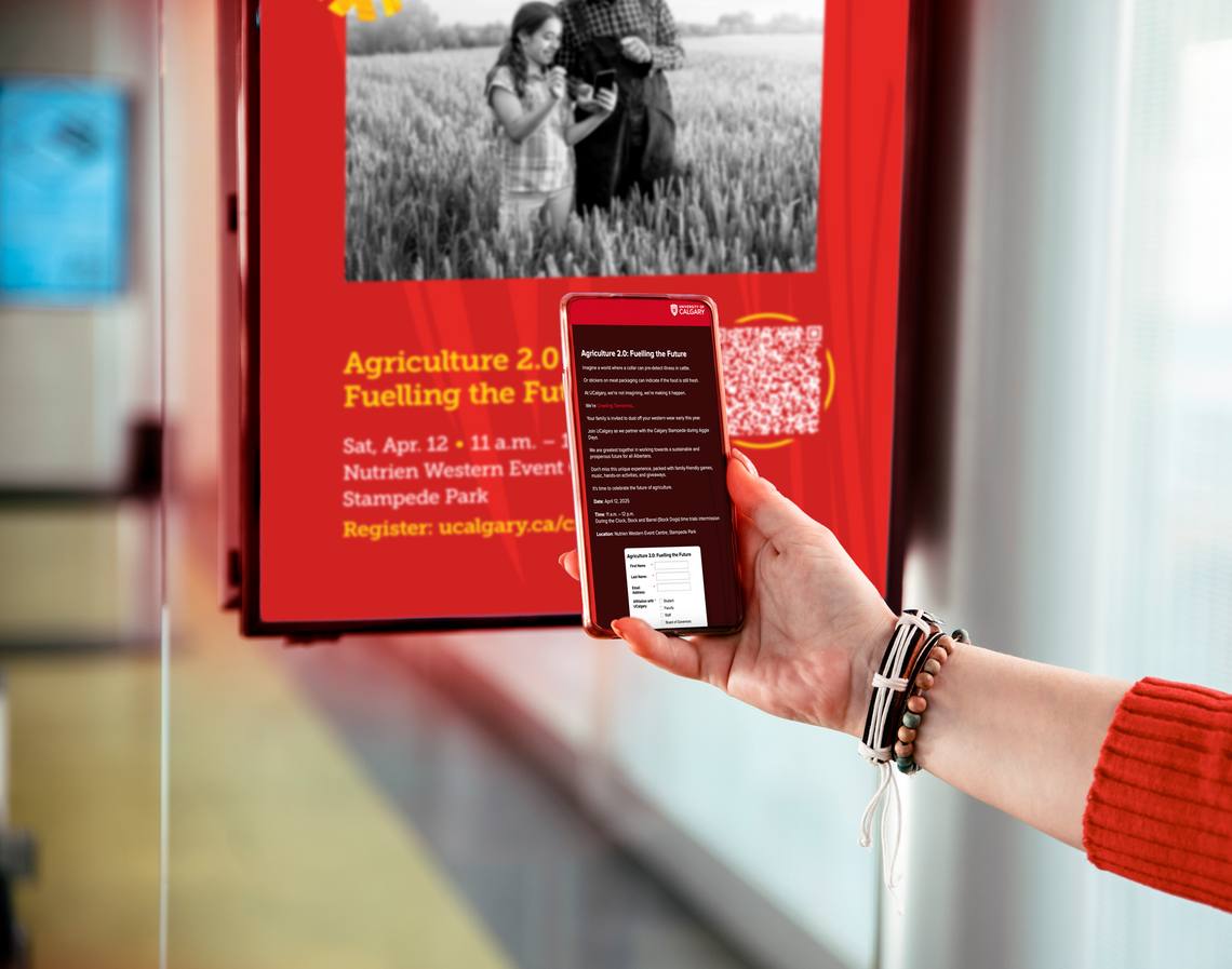 Using a QR code A figure holding a phone up to a digital board, scanning a QR code to register for an event