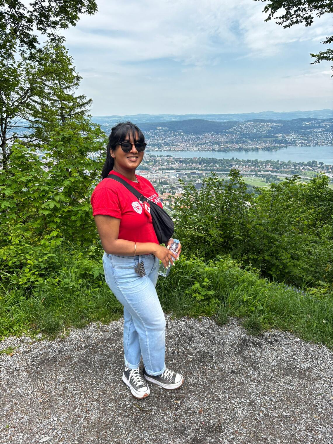 Student standing at viewpoint in red UCalgary tshirt 