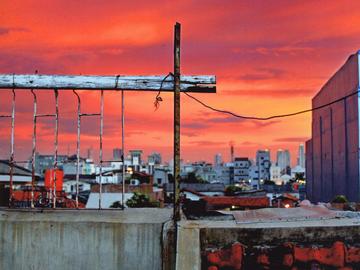 Image from a roof looking over city skyline with red clouds