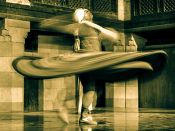 Image of person spinning in a dance with long robes