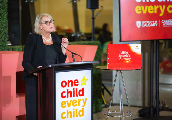 Dr. Susa Benseler speaks at a podium during the One Child Every Child launch event.