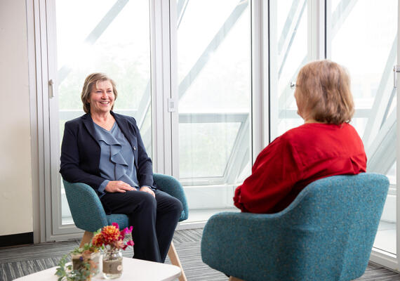Dr. Ellen Perrault speaks with a colleague in an office.
