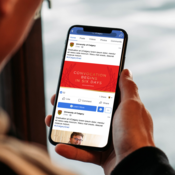 A mobile phone showing a red graphic in a social media post