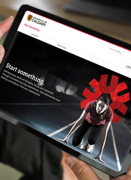 Hands holding a tablet with the Start something webpage 