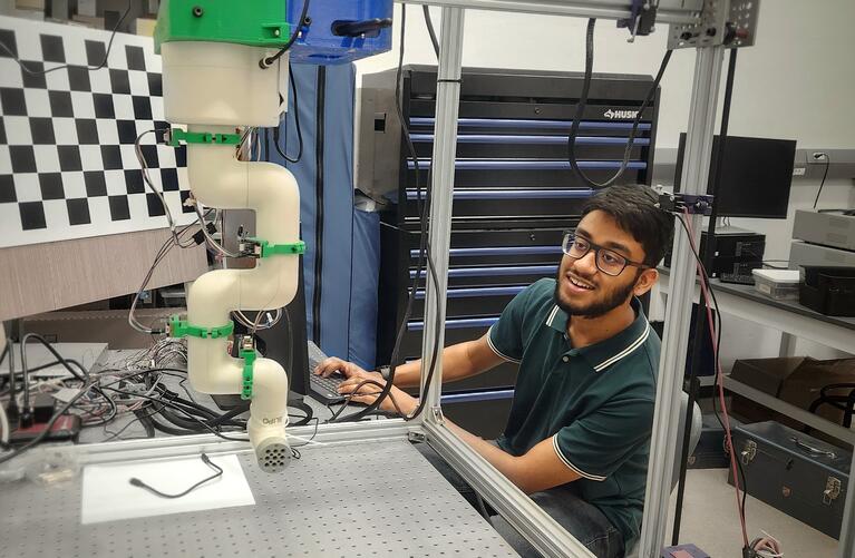 Nabeel Khan in a lab working with electronic equipment.