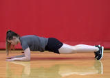 Athlete performing front plank on elbows exercise