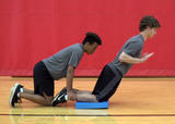 Athletes performing nordic hamstring curl exercise